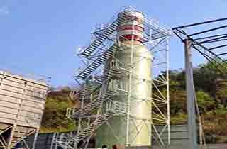 FRP access platforms, structural profiles, and safety barriers installed along the external framework of a chemical distillation tower.